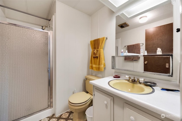 bathroom featuring an enclosed shower, vanity, and toilet