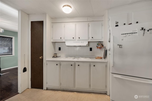 kitchen featuring white appliances and white cabinetry