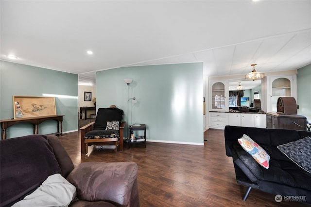 living room featuring dark wood-type flooring and a chandelier