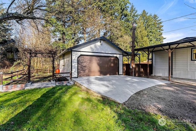 garage featuring a lawn and a carport