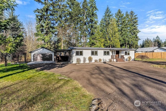 view of front facade featuring a front yard, an outdoor structure, a carport, and a garage