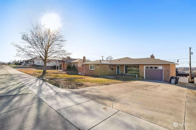 single story home featuring a garage and a front yard