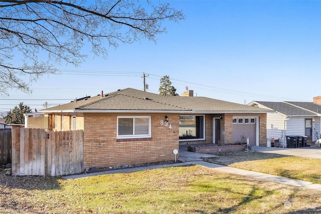 single story home with a garage and a front yard