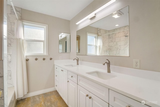 bathroom featuring shower / bath combo with shower curtain, a healthy amount of sunlight, and vanity