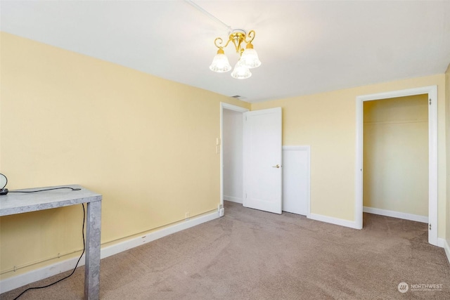 unfurnished bedroom featuring light carpet, a chandelier, and a closet