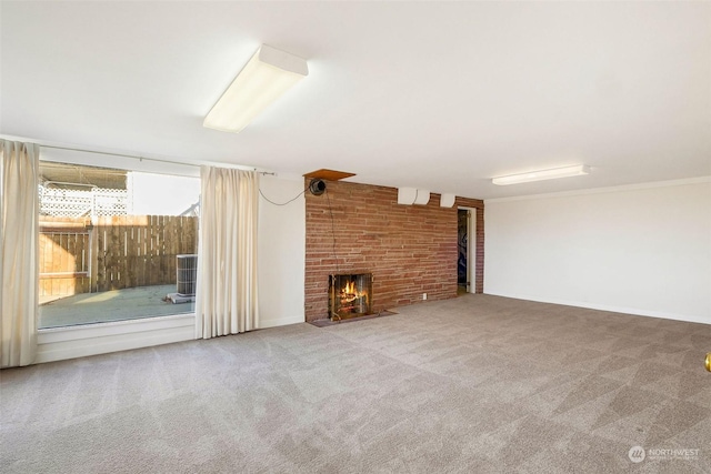 unfurnished living room with carpet and a fireplace