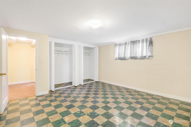 unfurnished bedroom featuring two closets