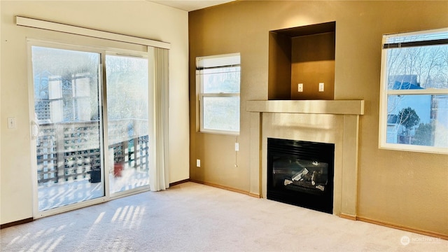 unfurnished living room with light colored carpet