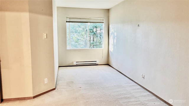 carpeted spare room featuring baseboard heating