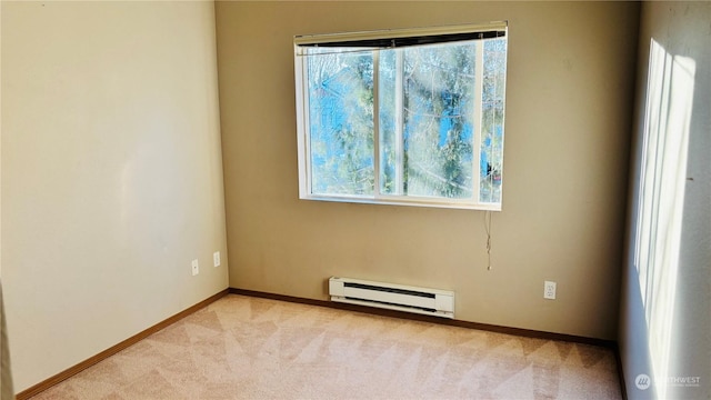 spare room featuring light colored carpet and baseboard heating