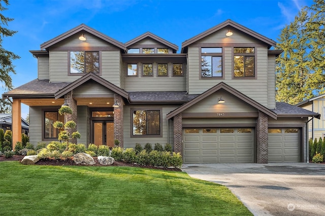 view of front of home featuring a garage and a front lawn