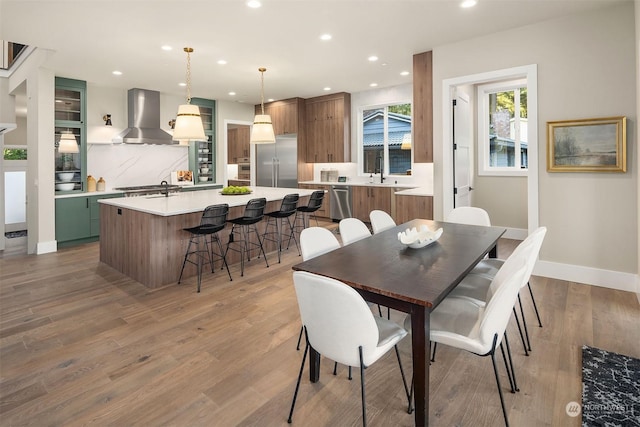 dining area with sink and wood-type flooring