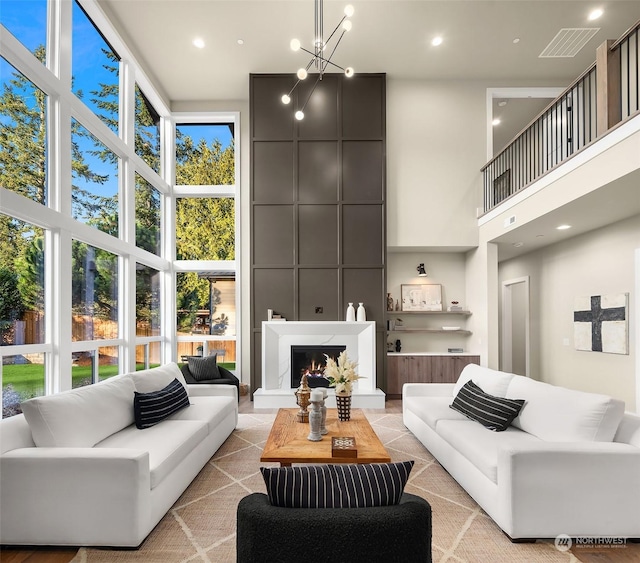 living room featuring a high ceiling and a notable chandelier