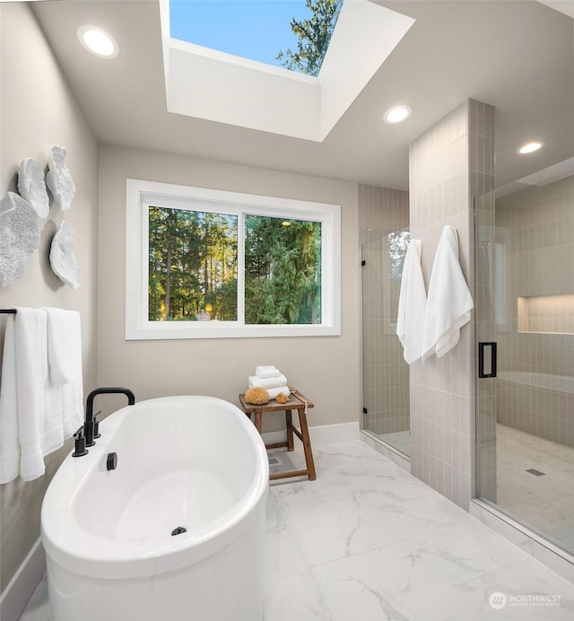 bathroom with plenty of natural light, a skylight, and independent shower and bath