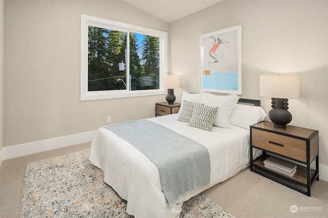 carpeted bedroom featuring lofted ceiling