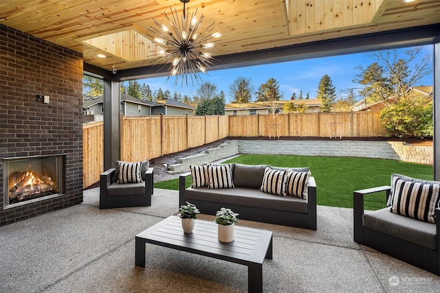 view of patio with an outdoor living space with a fireplace