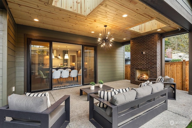 view of patio with an outdoor living space with a fireplace