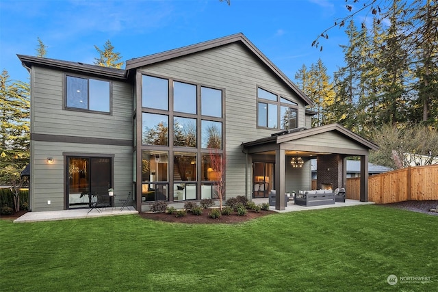 rear view of property with a patio area, a lawn, and outdoor lounge area