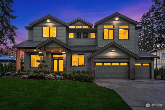 view of front of house with a garage and a lawn