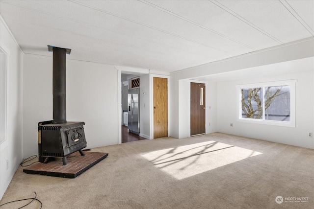 living room featuring carpet flooring and a wood stove