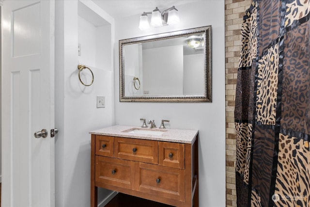 bathroom featuring vanity and a shower