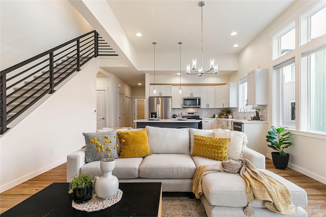 living room with hardwood / wood-style floors and a chandelier