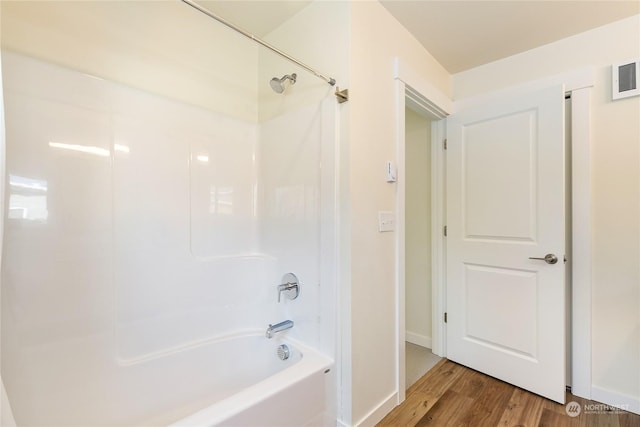 bathroom with wood-type flooring and shower / washtub combination