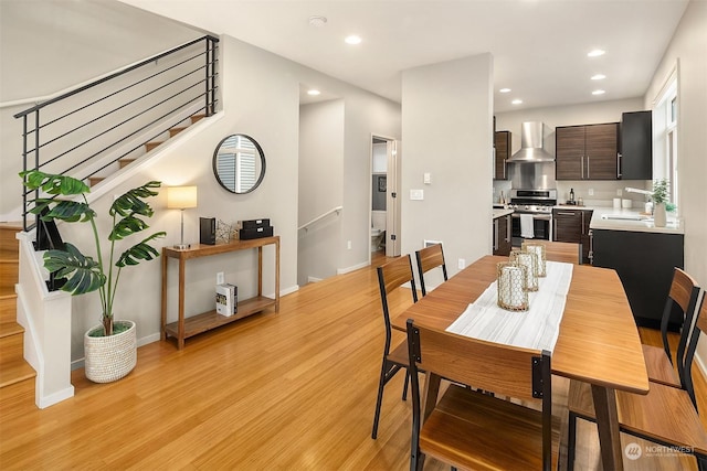 dining space with sink and light wood-type flooring