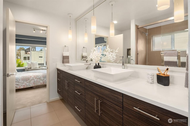 bathroom featuring tile patterned floors, vanity, and a shower