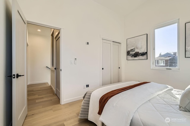 bedroom featuring light hardwood / wood-style flooring and a closet