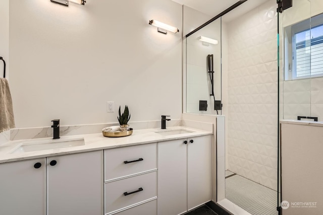 bathroom with tiled shower and vanity