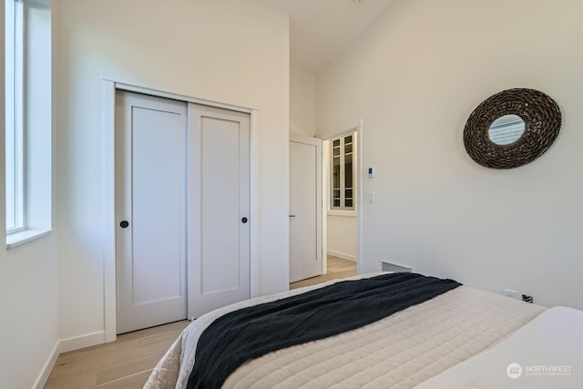 bedroom featuring a closet and light wood-type flooring