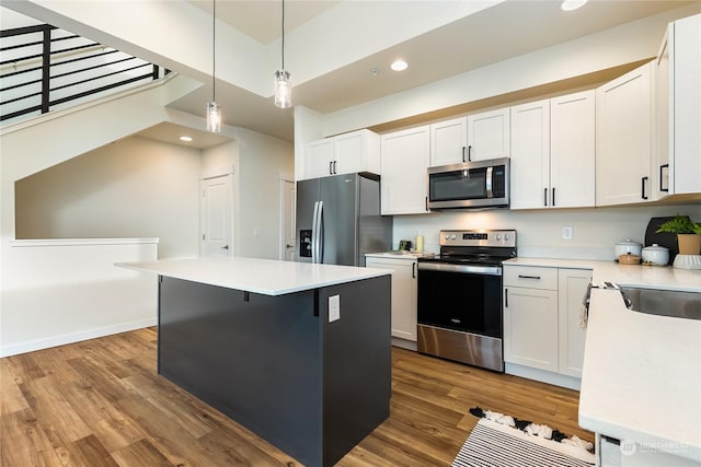 kitchen featuring white cabinetry, stainless steel appliances, and a center island