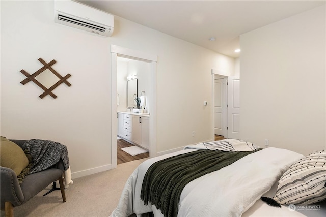 bedroom featuring light colored carpet, connected bathroom, and a wall mounted AC