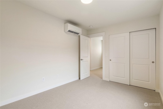 unfurnished bedroom featuring an AC wall unit, light carpet, and a closet