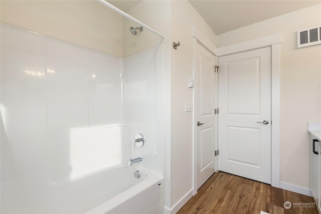 bathroom with shower / tub combination and wood-type flooring