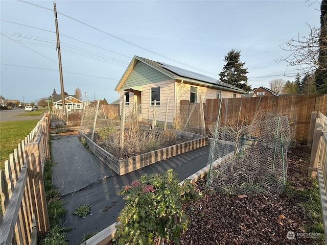 rear view of property with solar panels