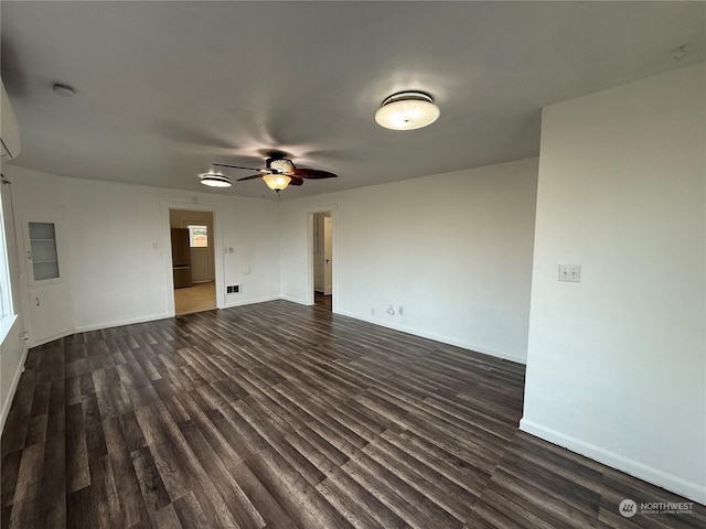 unfurnished room with dark hardwood / wood-style floors and ceiling fan