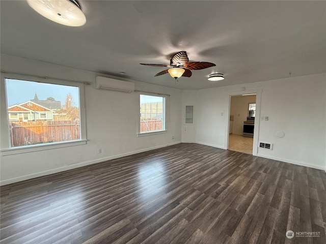 empty room featuring ceiling fan, dark wood-type flooring, and a wall unit AC