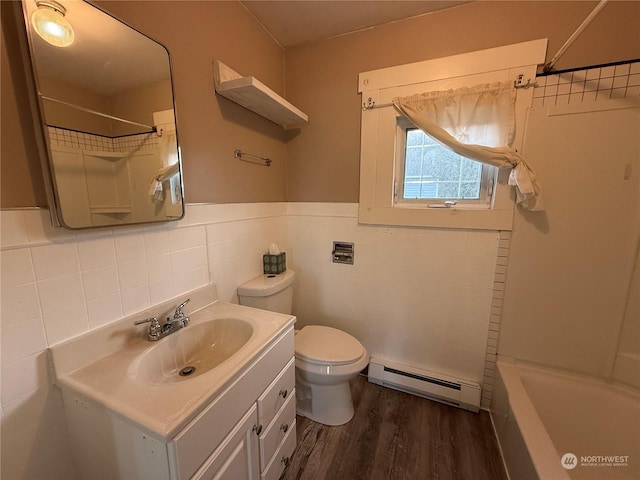 bathroom featuring a baseboard radiator, wood-type flooring, vanity, and toilet