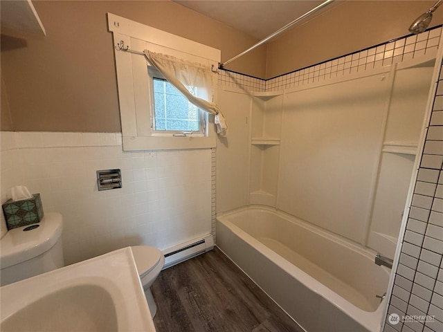 bathroom featuring tile walls, hardwood / wood-style floors, a baseboard radiator, bathtub / shower combination, and toilet