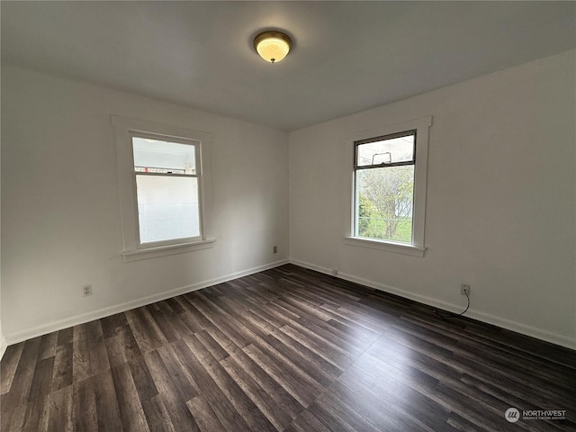 empty room featuring dark wood-type flooring