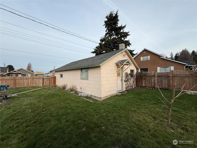 view of outbuilding featuring a yard