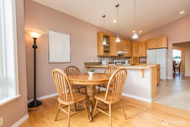 dining space with recessed lighting, vaulted ceiling, light wood-style flooring, and baseboards