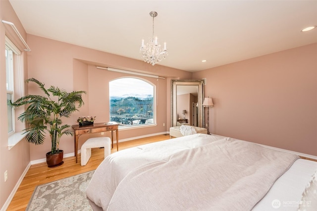 bedroom featuring light wood-type flooring, baseboards, a chandelier, and recessed lighting