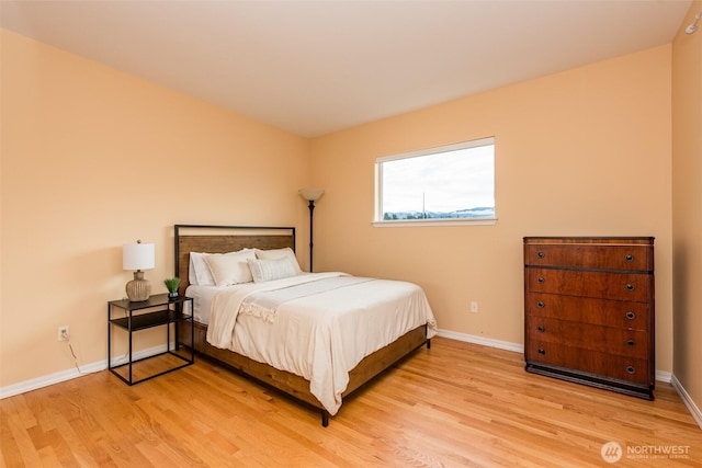 bedroom featuring light wood-style flooring and baseboards