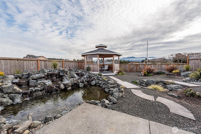 view of yard featuring a fenced backyard and a gazebo