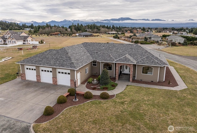 ranch-style home with driveway, a residential view, an attached garage, a mountain view, and brick siding