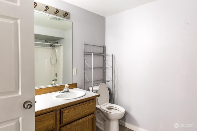 bathroom with visible vents, vanity, toilet, and walk in shower