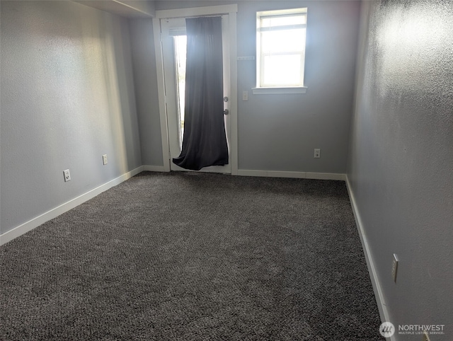 empty room with carpet floors and baseboards